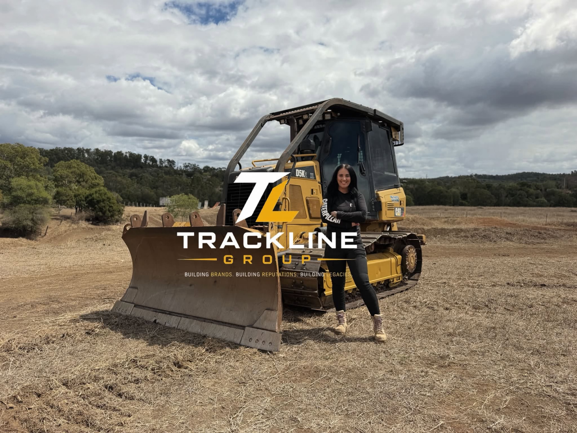 Michelle Thurrowgood of Trackline Group standing beside a Caterpillar dozer on an Australian earthmoving site